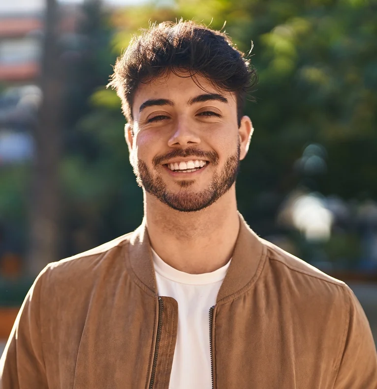 Young man smiling outside after LASIK